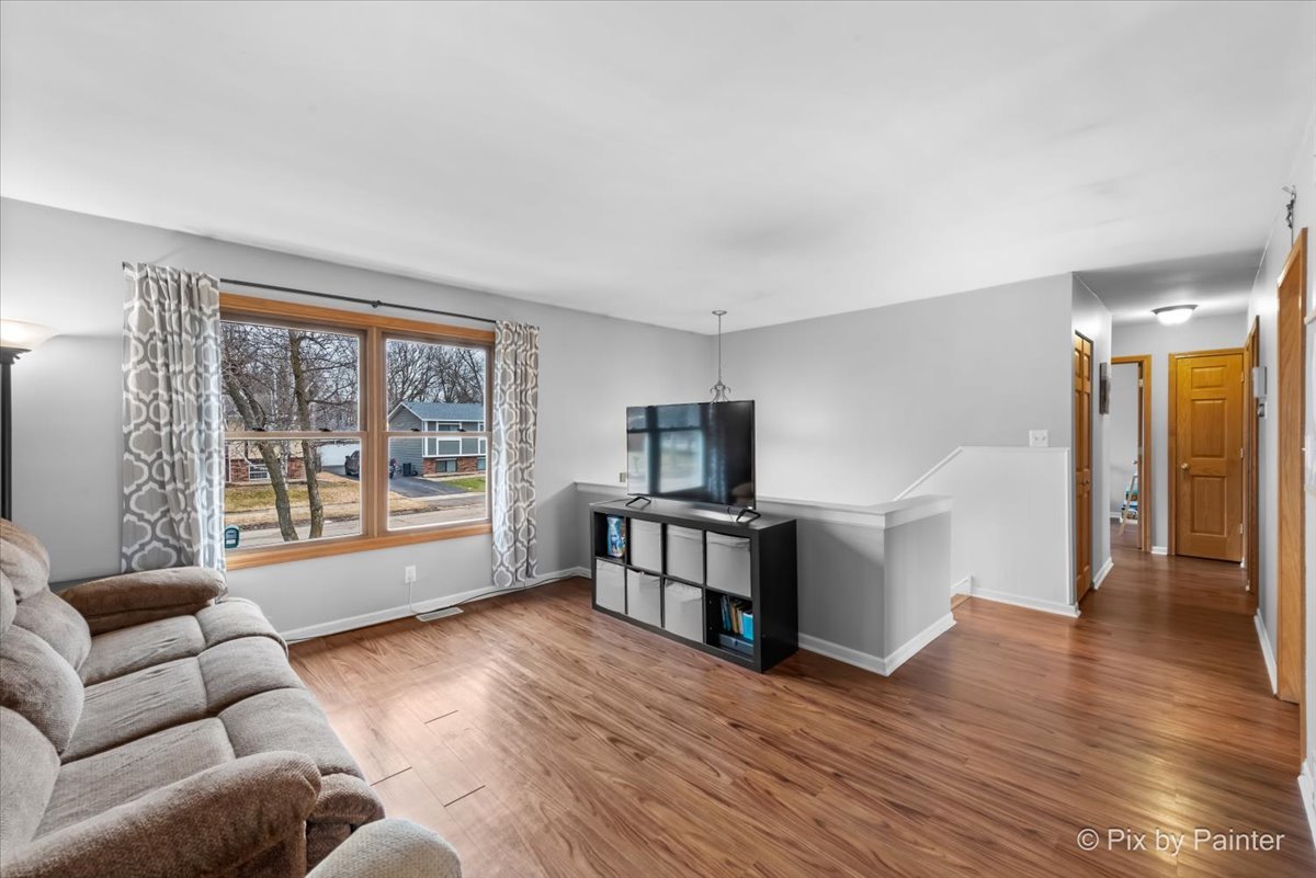 113 Springleaf Drive Bolingbrook, IL 60440 - Photo 3 of 24 a living room with furniture and a flat screen tv