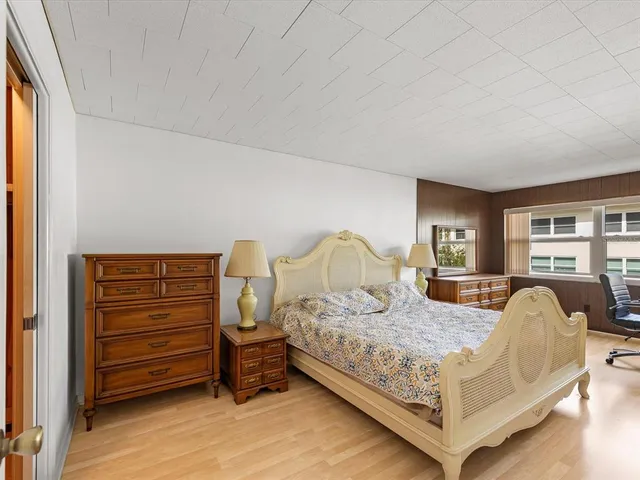 a bedroom with a bed and a dresser