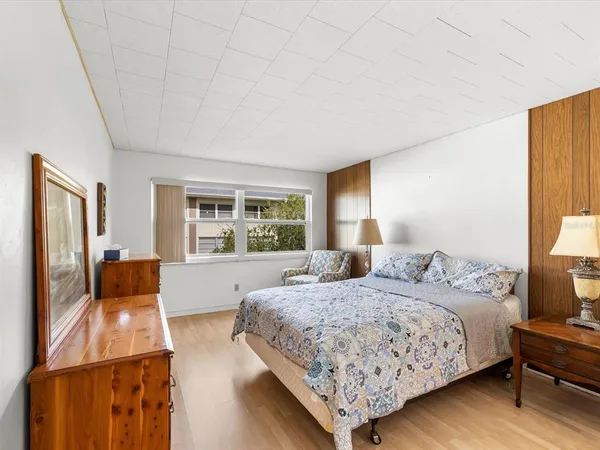 a bedroom with a large bed and a couch