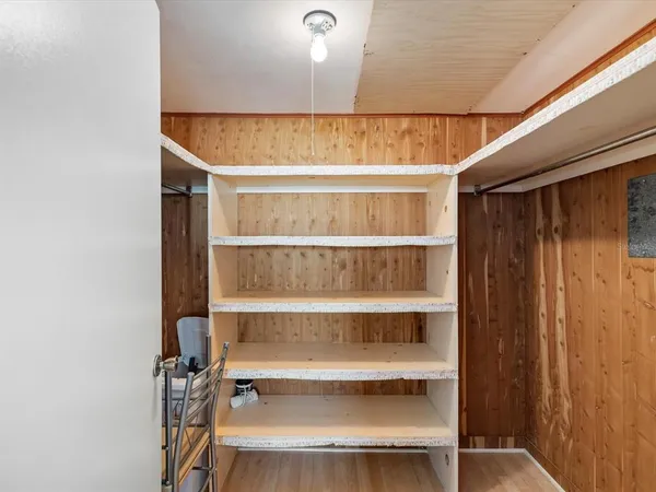 a view of a room with rack on the wall and a window