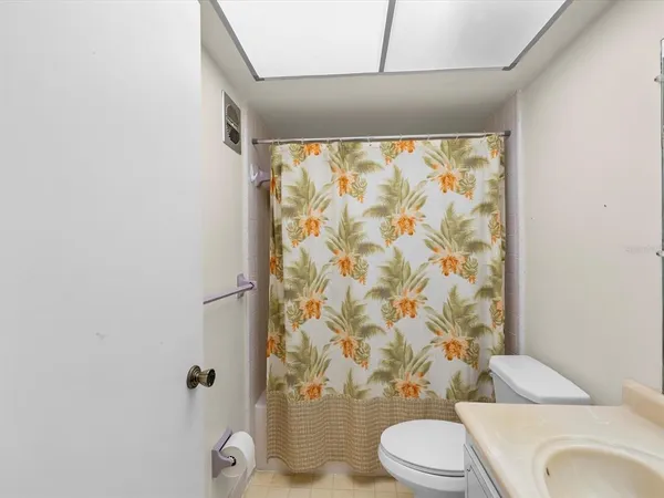 a white toilet sitting next to a shower curtain