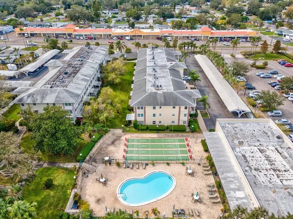 a view of a swimming pool with a yard and sitting space