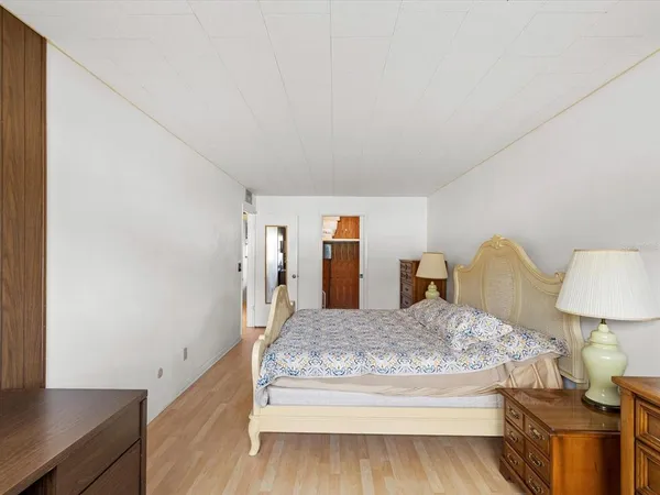 a bedroom with a bed and a lamp on table