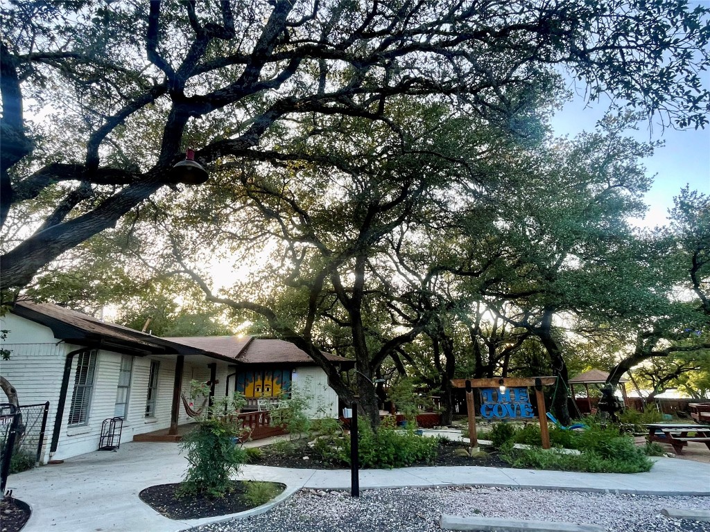 17357 West Beach Road Austin, TX 78734 - Photo 2 of 32 a front view of a house with garden