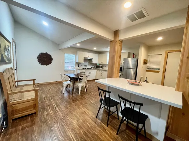 a view of a dining room with furniture and wooden floor