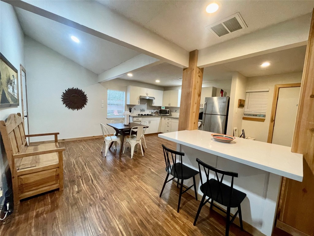 17357 West Beach Road Austin, TX 78734 - Photo 4 of 32 a view of a dining room with furniture and wooden floor