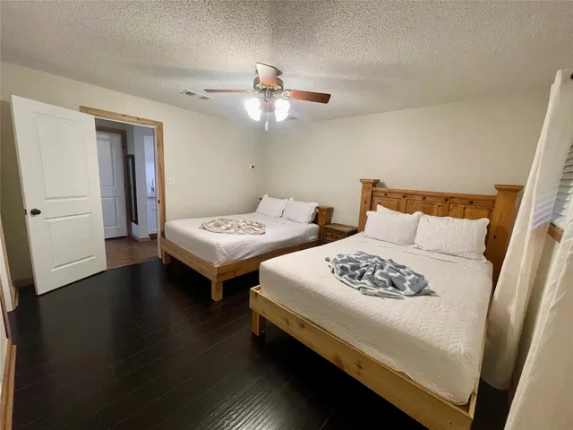 a bedroom with two beds and a table