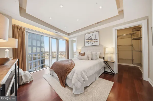 a bedroom with a large bed and a large window