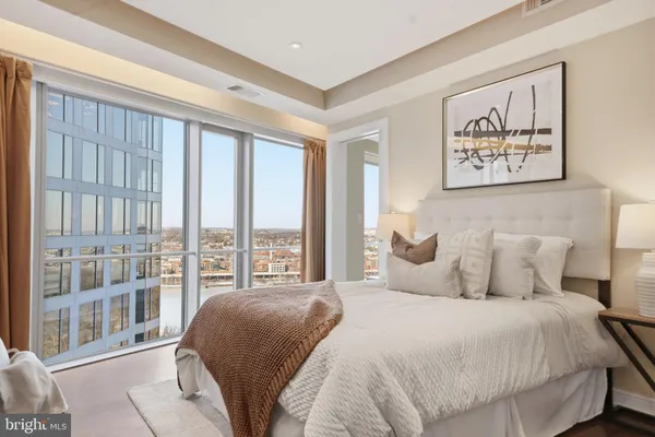 a bedroom with a large bed and a large window