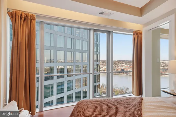 a bedroom with a bed and a window