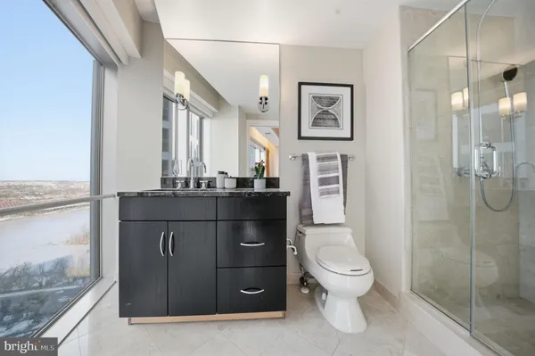 a bathroom with a toilet a sink and shower