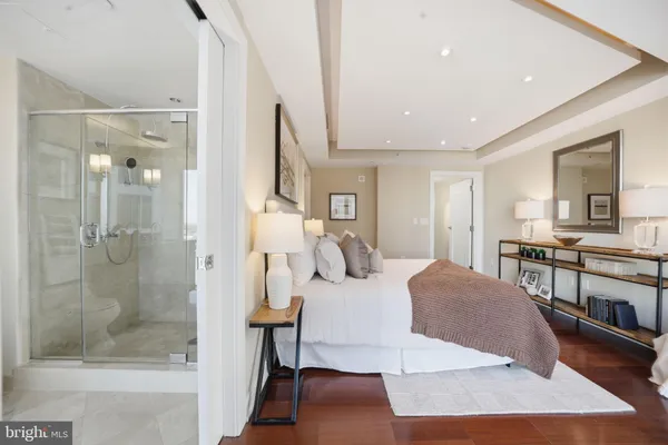 a large bedroom with a bed and a mirror