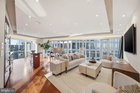 a living room with fireplace furniture and a flat screen tv