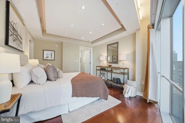 a bedroom with a bed and a view of kitchen