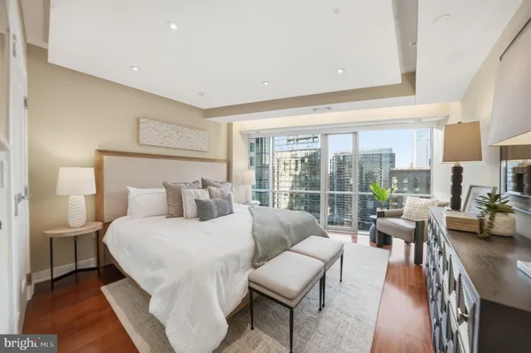 a bedroom with a bed and a large window