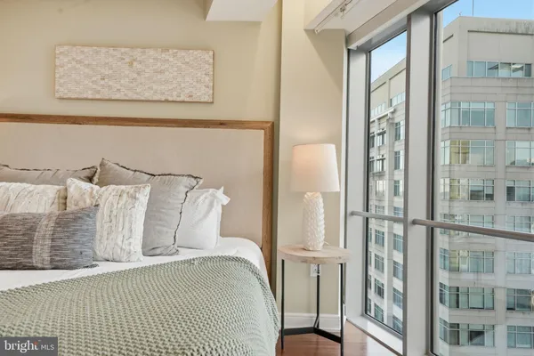 a bedroom with a bed and glass window