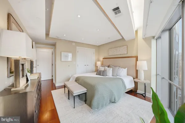 a bedroom with a bed and wooden floor