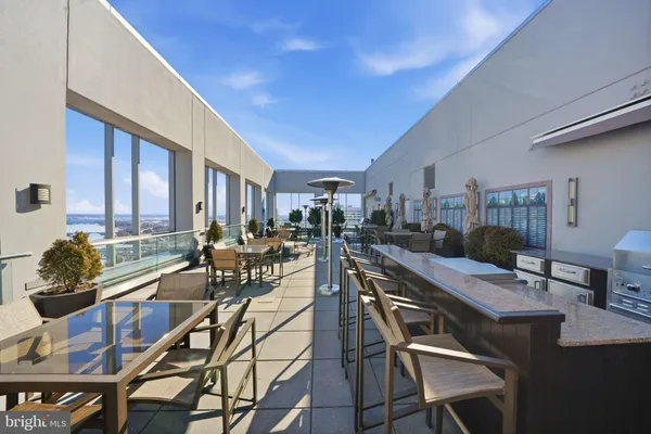 a outdoor space with lots of tables a garden view and chairs