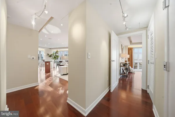 a view of a hallway view with three living room and wooden floor
