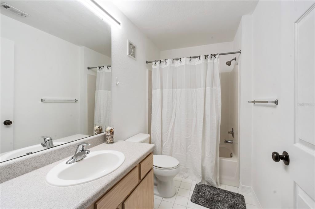 5475 Vineland Road, Unit 8302 Orlando, FL 32811 - Photo 11 of 12 a bathroom with a sink toilet and shower