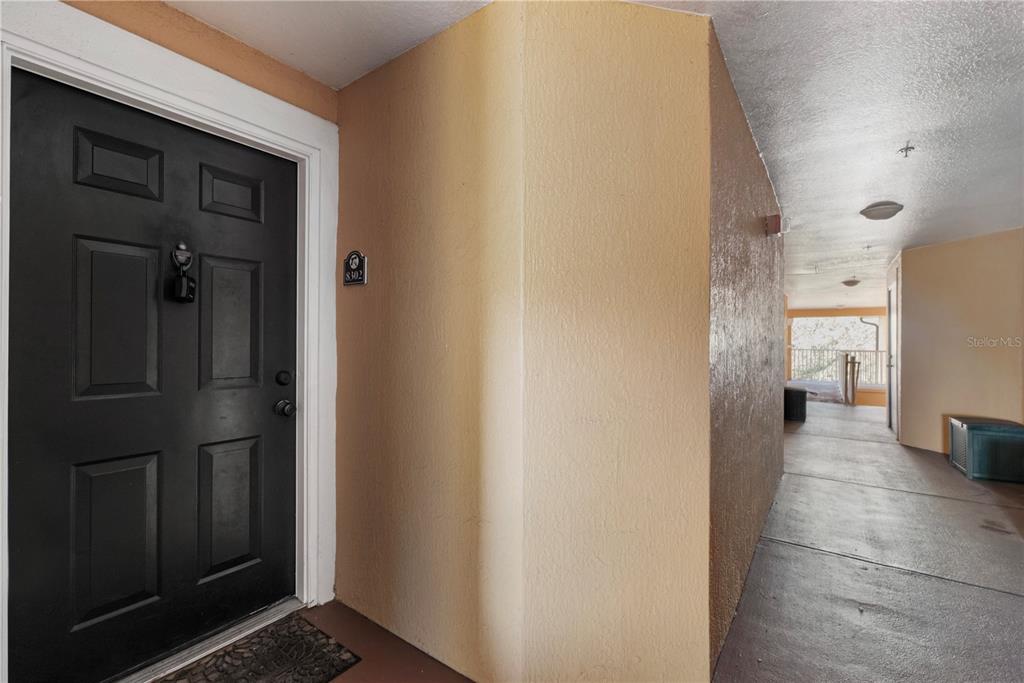 5475 Vineland Road, Unit 8302 Orlando, FL 32811 - Photo 2 of 12 a view of a bathroom from a hallway