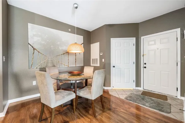 a dining room with furniture and wooden floor