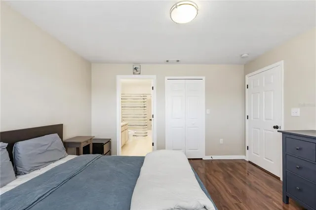 a bedroom with a bed and cabinets