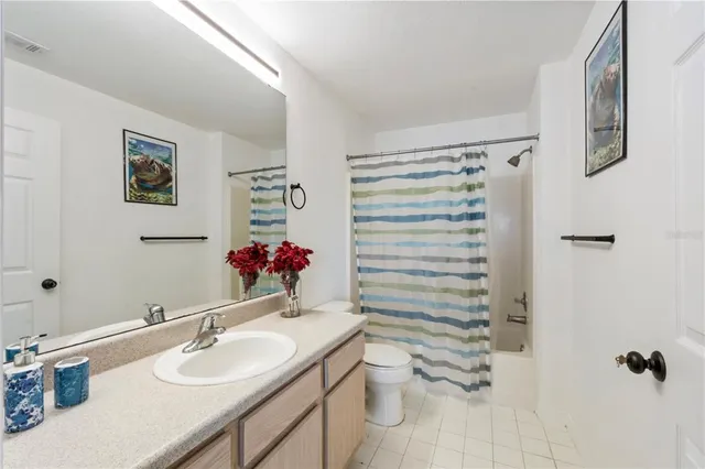 a bathroom with a sink vanity mirror and toilet