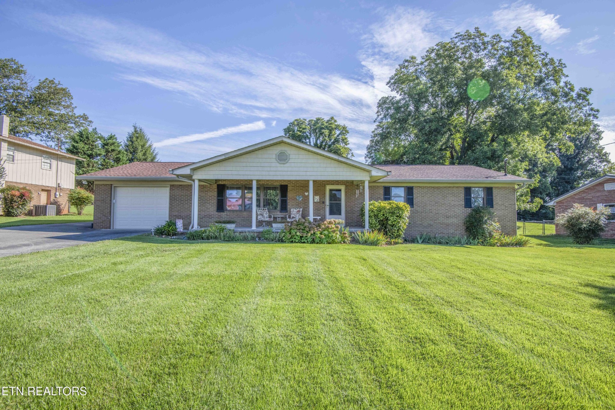 a front view of a house with a garden