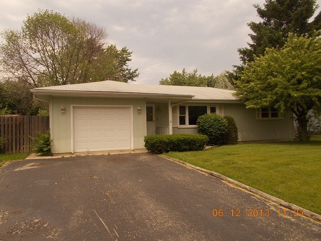 613 Stonegate Road New Lenox, IL 60451 - Photo 1 of 8 a front view of a house with a yard and garage