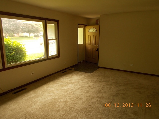 613 Stonegate Road New Lenox, IL 60451 - Photo 2 of 8 a view of an empty room with a window