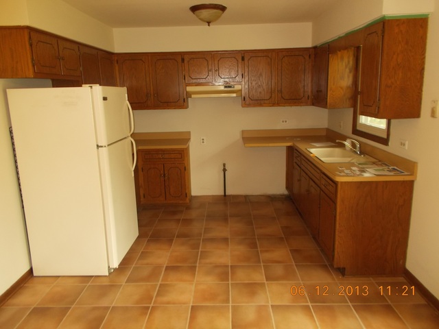613 Stonegate Road New Lenox, IL 60451 - Photo 4 of 8 a kitchen with a refrigerator a stove top oven and cabinets
