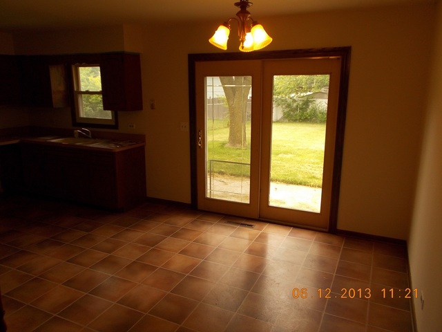 613 Stonegate Road New Lenox, IL 60451 - Photo 5 of 8 a view of an empty room with a window