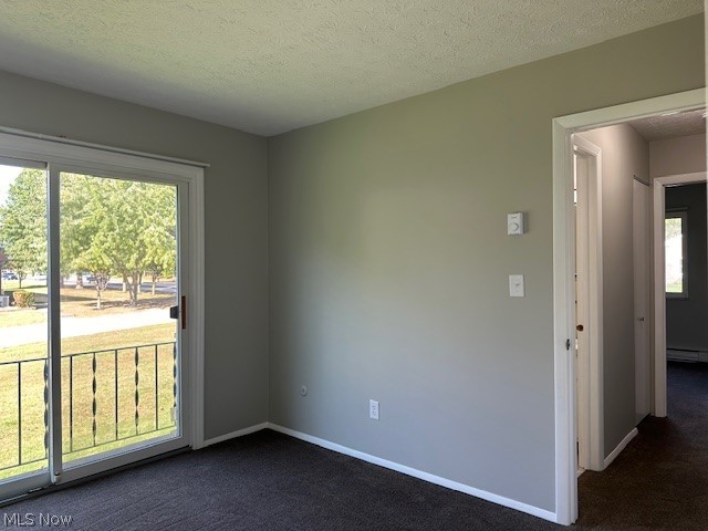 4376 Darrow Road, Unit 7 Stow, OH 44224 - Photo 15 of 23 Carpeted spare room with a textured ceiling and baseboard heating