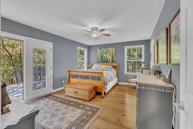 a spacious bedroom with a large bed and a chandelier