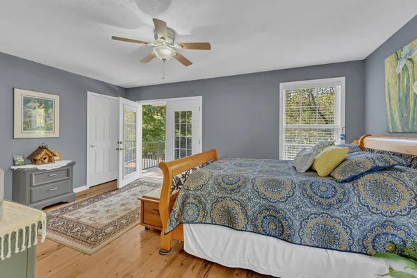 a bedroom with two beds and a large window