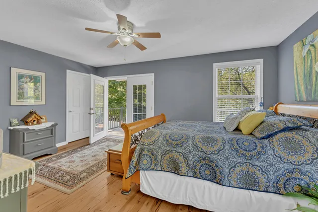 a bedroom with two beds and a large window