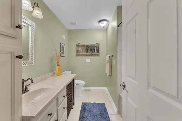 a bathroom with a sink a mirror and a shower