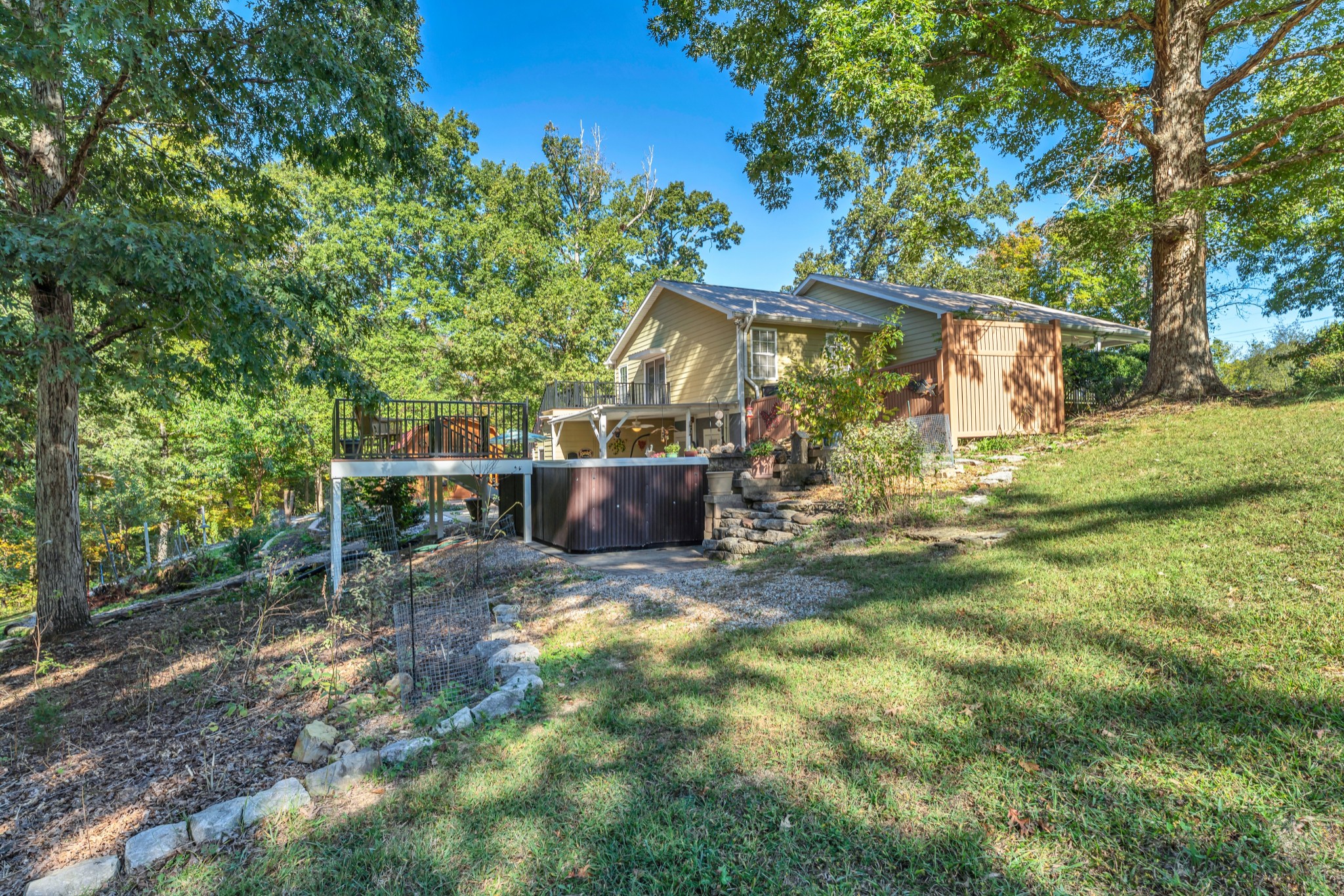 1475 Petty Road White Bluff, TN 37187 - Photo 35 of 55 a view of a backyard with table and chairs and potted plants and large tree