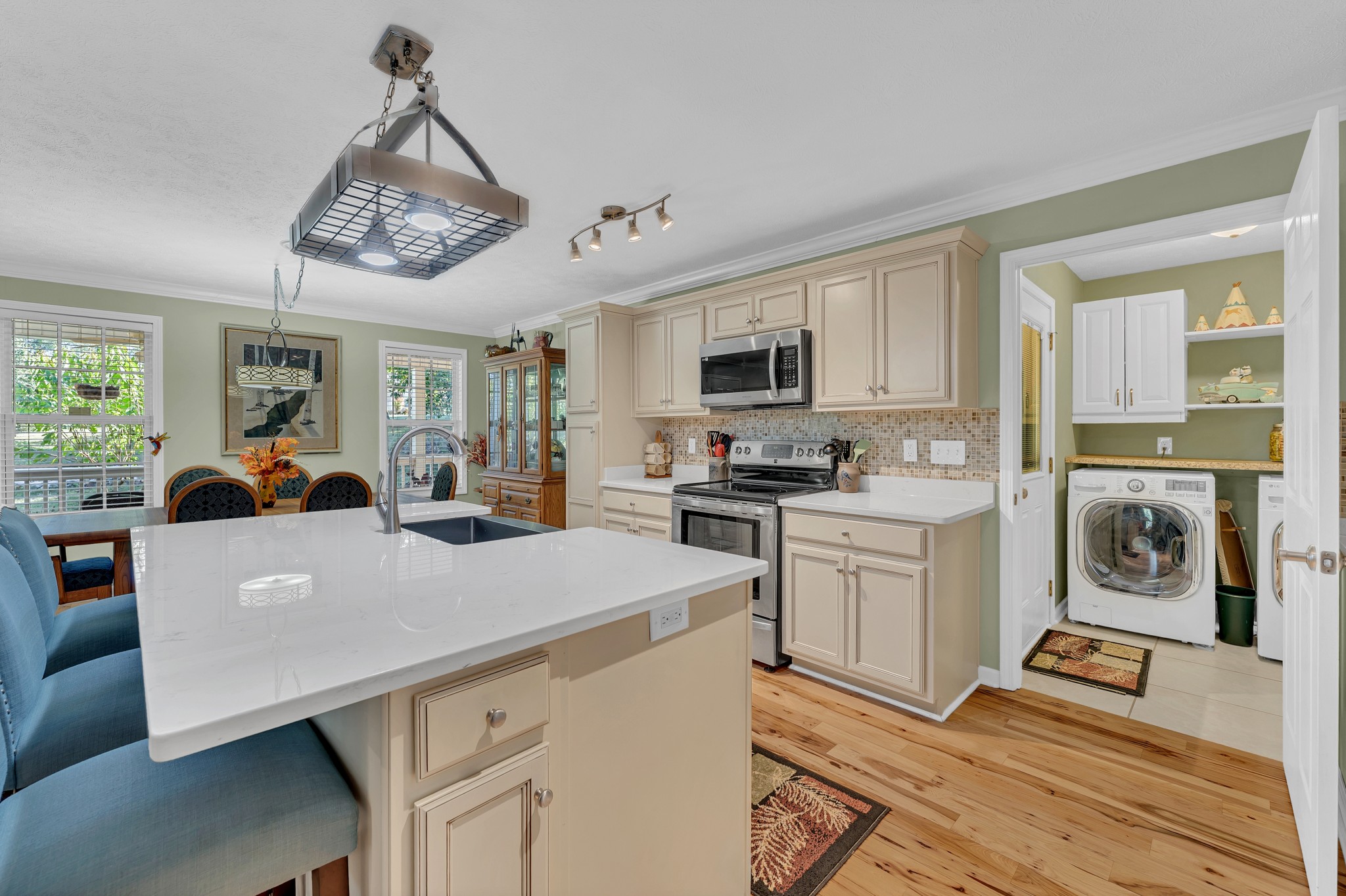1475 Petty Road White Bluff, TN 37187 - Photo 9 of 55 a open kitchen with a refrigerator a stove top oven a sink dishwasher a dining table and chairs with wooden floor