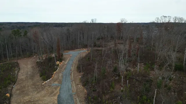 a view of a house with a forest