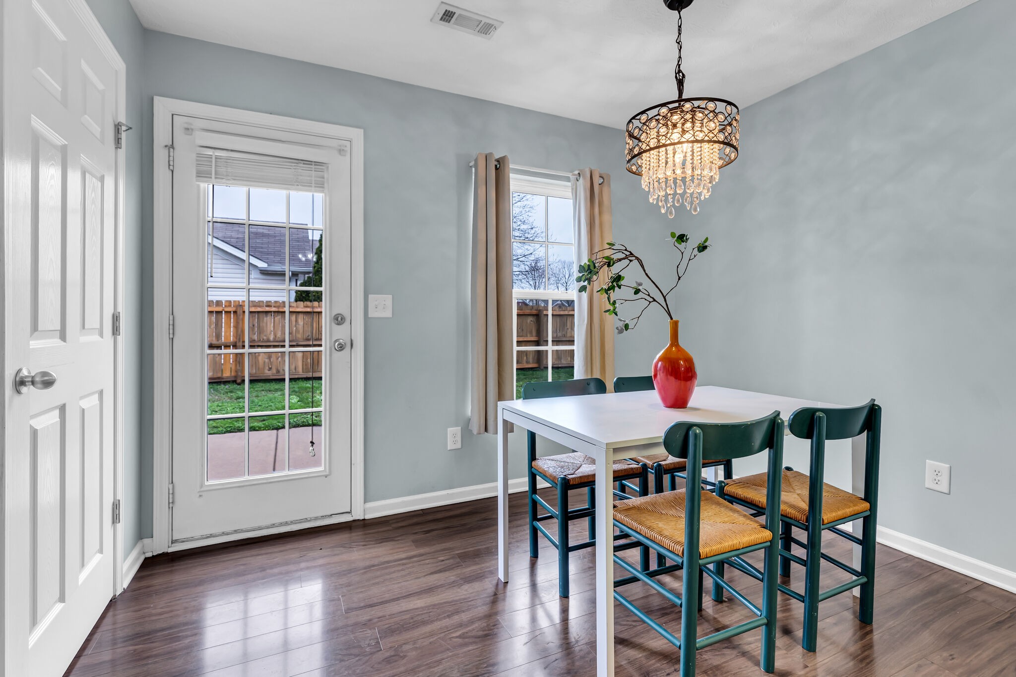 4026 Deer Run Trace Spring Hill, TN 37174 - Photo 12 of 29 a view of a dining room with furniture a chandelier and wooden floor