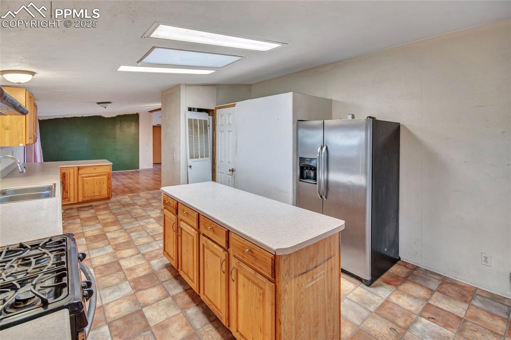 7940 Edison Road Yoder, CO 80864 - Photo 16 of 38 a kitchen with stainless steel appliances a refrigerator and a stove