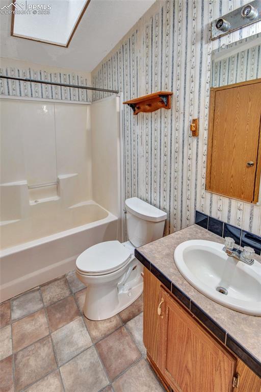 7940 Edison Road Yoder, CO 80864 - Photo 21 of 38 a bathroom with a granite countertop sink toilet and shower