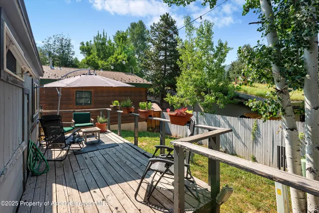 a view of balcony with wooden floor and outdoor seating