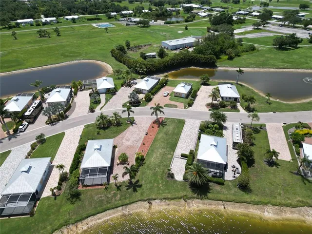 an aerial view of a house with a garden and lake view