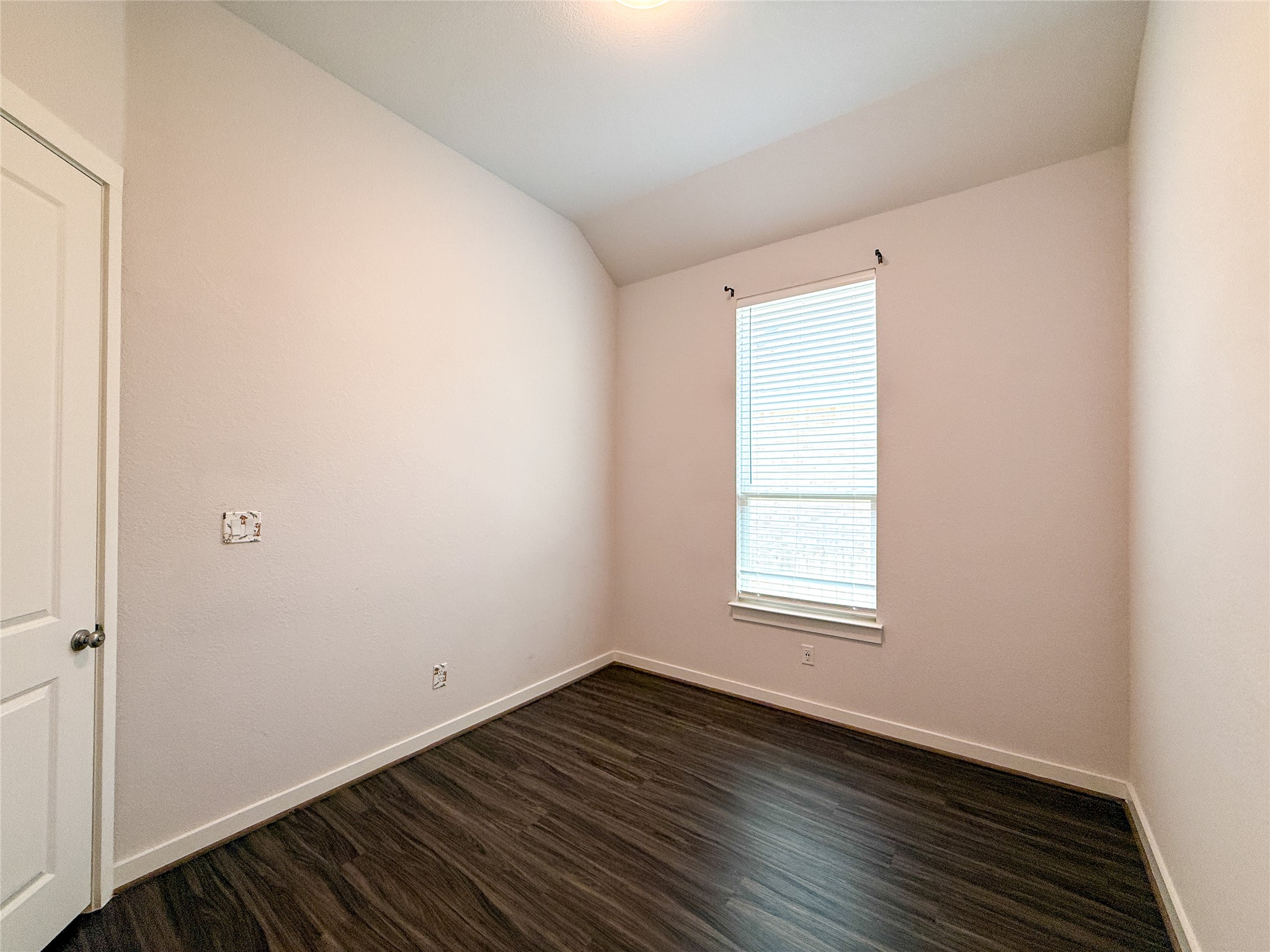 249 Heartleaf Road San Marcos, TX 78666 - Photo 28 of 38 Rich hardwood-style flooring extends through this comfortable bedroom, offering a serene personal retreat.