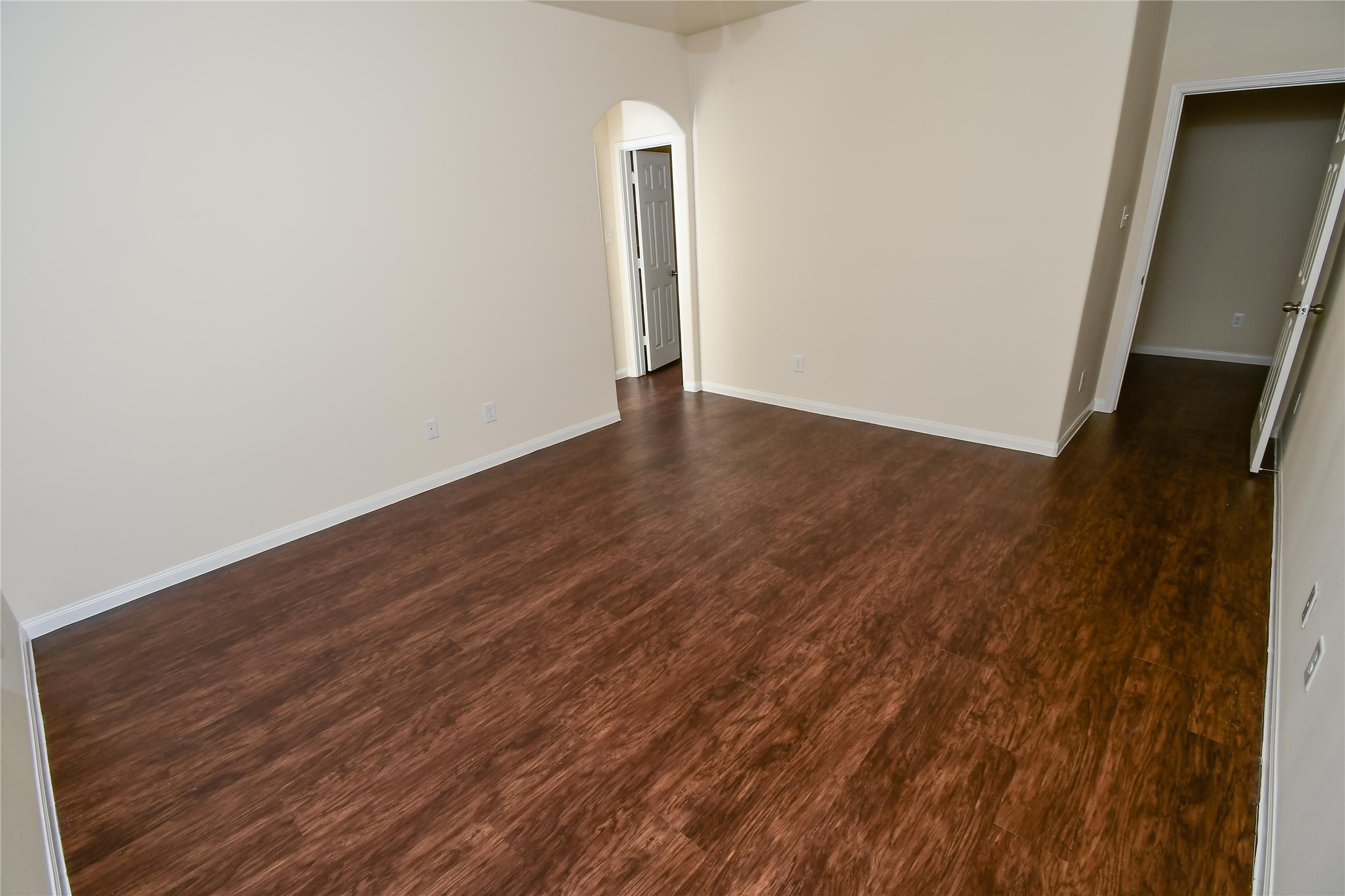 12419 Maura Lane Houston, TX 77044 - Photo 7 of 11 an empty room with wooden floor and mirror