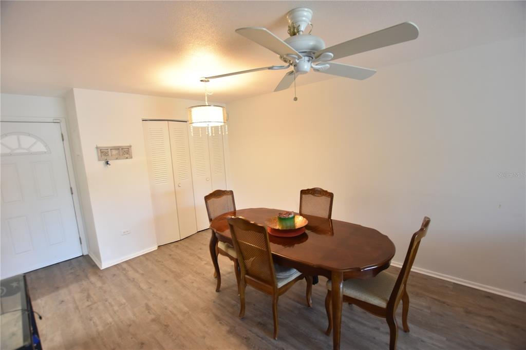 3900 Roxane Boulevard, Unit 10A Sarasota, FL 34235 - Photo 3 of 10 a view of a dining room with furniture and wooden floor
