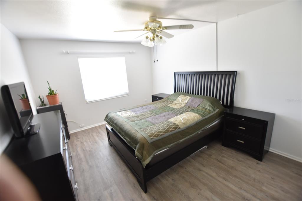 3900 Roxane Boulevard, Unit 10A Sarasota, FL 34235 - Photo 6 of 10 a bedroom with a bed and a chandelier